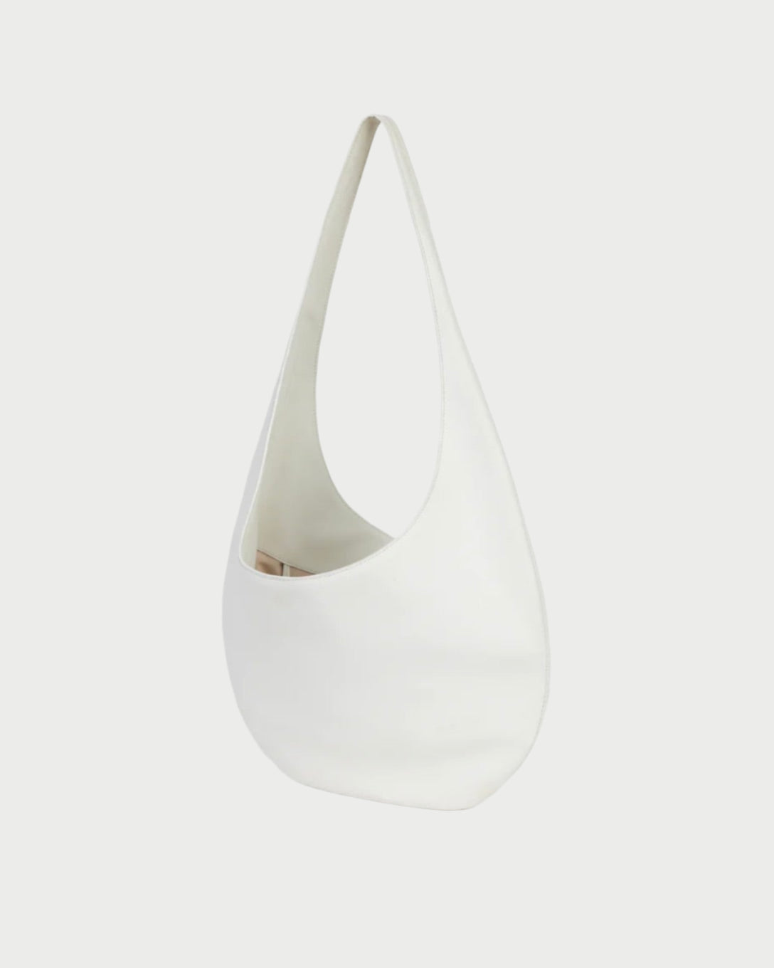 The H Hobo Bag by WE-AR4 is a minimalist white crescent-shaped design crafted from upcycled grain leather with a single strap, shown against a plain white background.