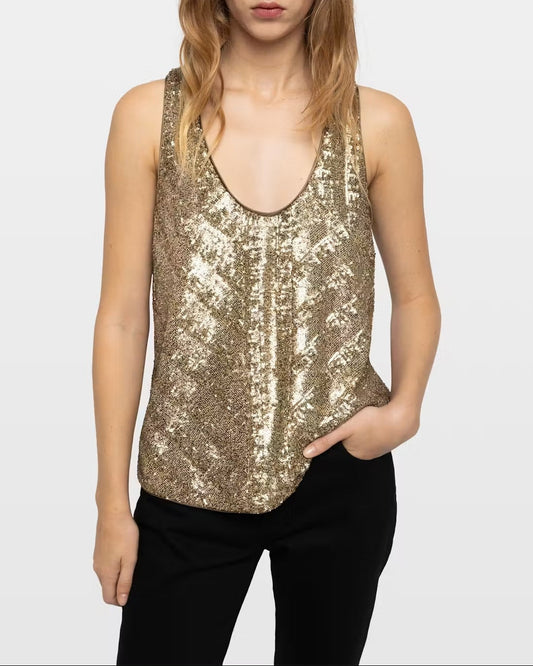 A sleeveless Zadig & Voltaire Tarys Sequin Tank in gold with a scoop neckline worn with black pants.