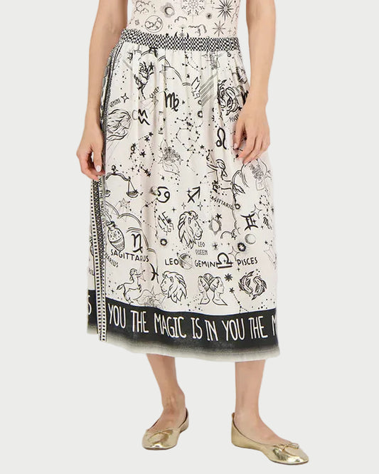 Woman wearing a white dress with black patterns and text on a white background