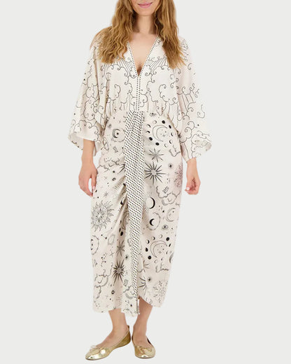 Woman wearing a white dress with black patterns on a white background