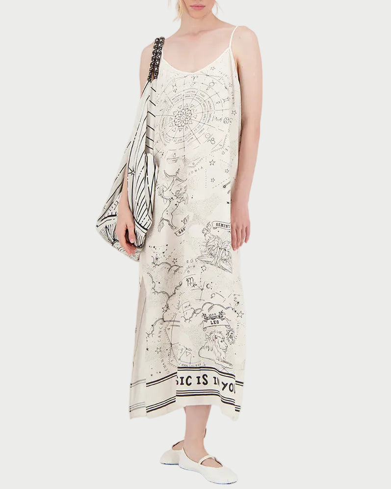 Woman wearing a long dress with star map design on a white background