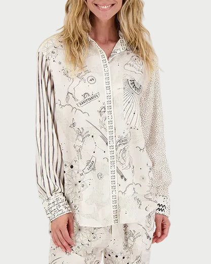 Woman wearing a white shirt with black patterns on a white background