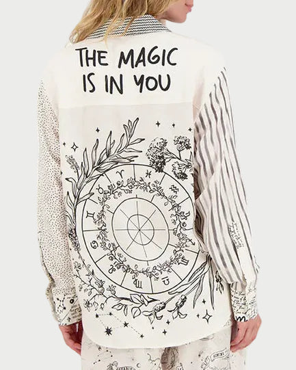 Person wearing a shirt with celestial design and text on a white background