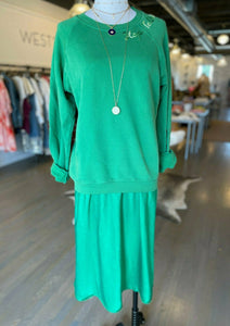 green slip dress with sweatshirt over it at west2westport.com